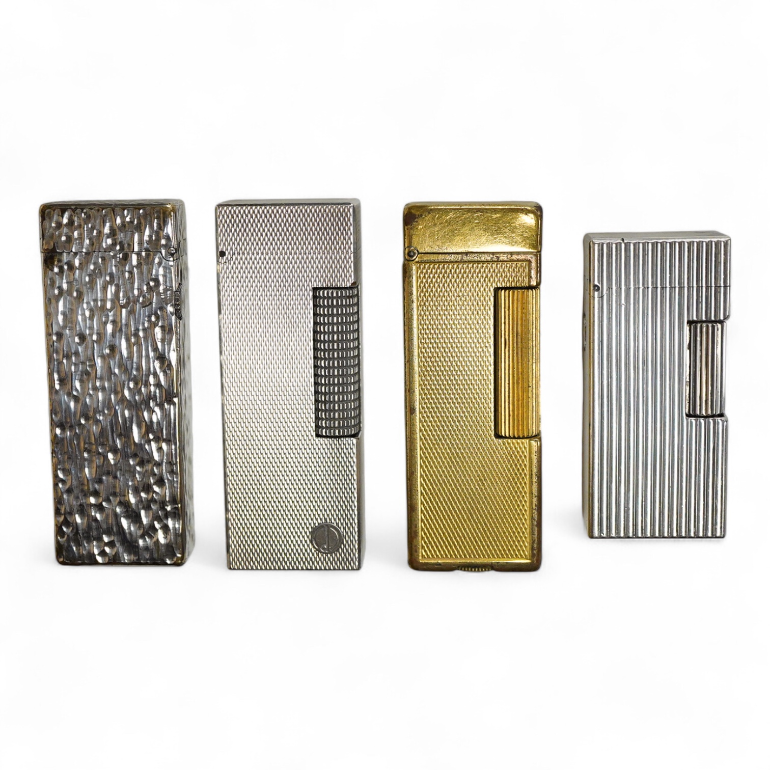 Three assorted plated Dunhill lighters and a gilt example, largest 6.5cm high